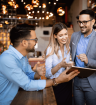 Great employees - three hsopitality workers smiling at a digital tablet