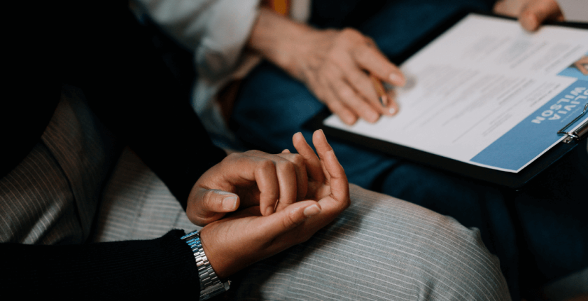 Image of two people sitting together looking through a curriculum vitae