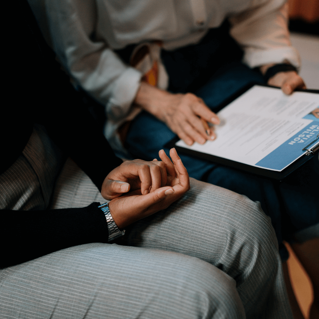 Image of two people sitting together looking through a curriculum vitae