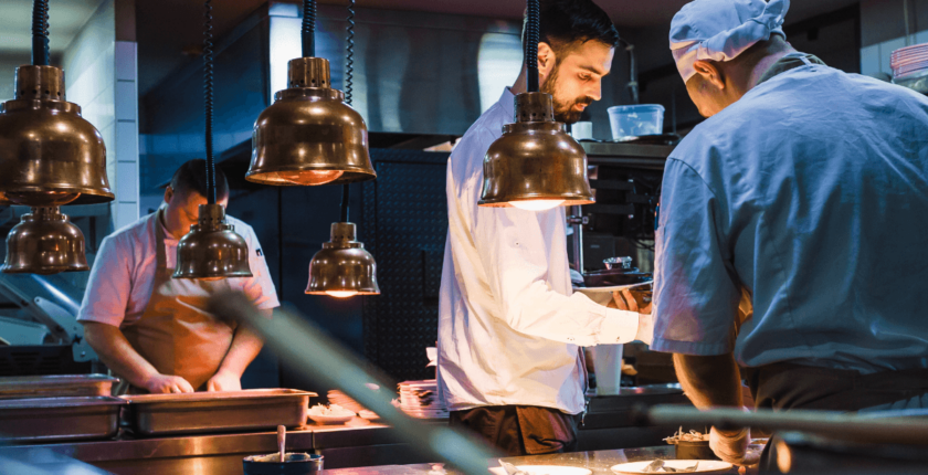 Professional kitchen with temporary chefs working