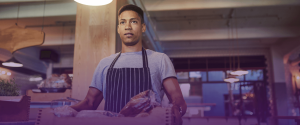 Image of a hospitality worker carrying a food delivery in a box - Hospitality Job Descriptions