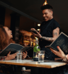 A Restaurant worker smiling on World Mental Health Day