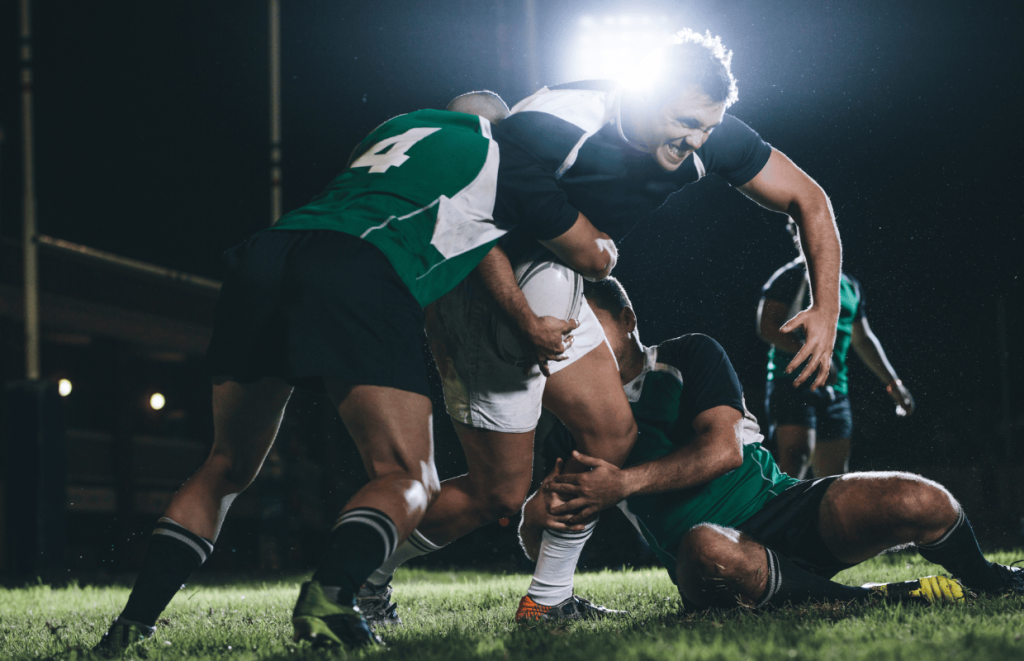 Event Jobs: Image of a 3 rugby players in a tackle