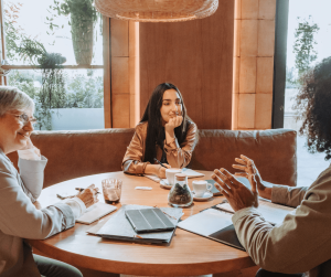 Image of a hospitality team talking at a round table