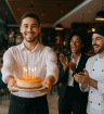 Waiter offering Platinum Hospitality an anniversary cake