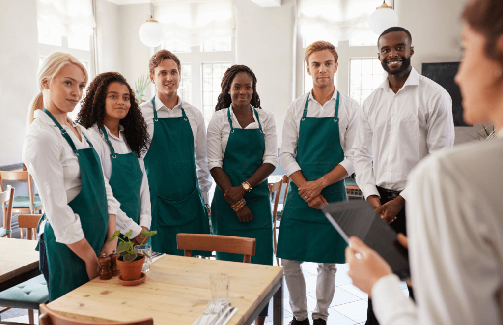 How to Handle Customer Complaints - group of hospitality workers taking direction from their manager