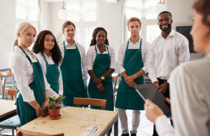 How to Handle Customer Complaints - group of hospitality workers taking direction from their manager