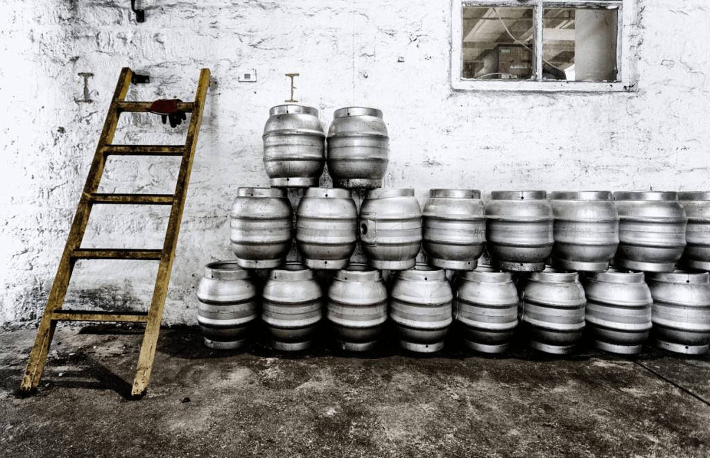 Teamwork Skills: Beer kegs piled up on one another next to a wooden ladder