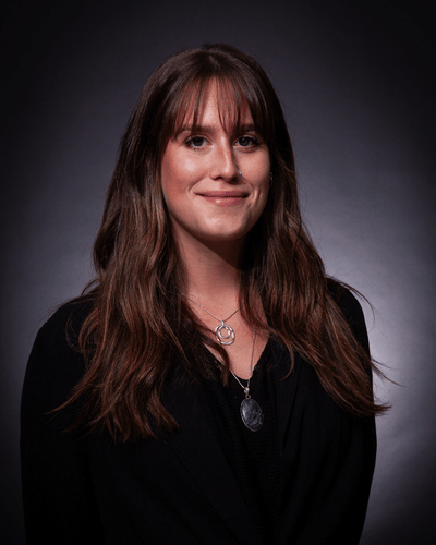 Portrait photo of Kyla Walker smiling, wearing a black top